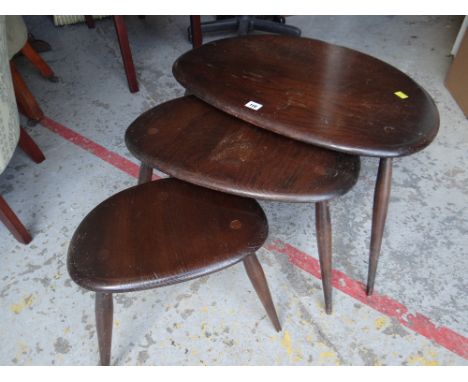 A nest of three mid-century Ercol 'Pebble' tables in dark wood