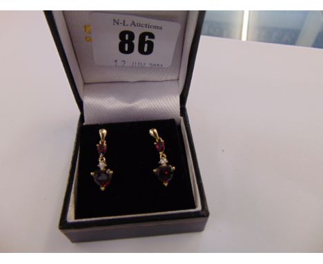 A pair of 9ct Gold Diamond and Ruby drop earrings