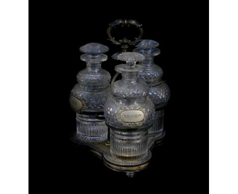 A Victorian silver plated three bottle cruet, containing three cut glass decanters and stoppers, with plated decanter labels,