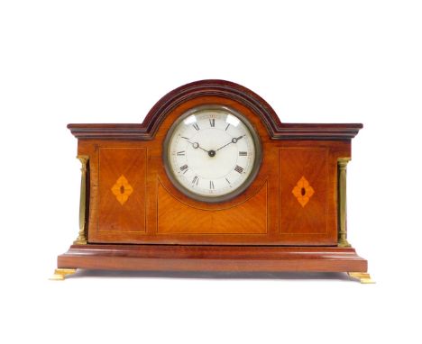 An Edwardian mahogany and inlaid mantel clock, circular dial bearing Roman numerals, clockwork movement with integral key, th
