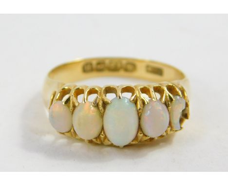 An 18ct gold and opal five stone ring, claw set, size N, 2.9g.