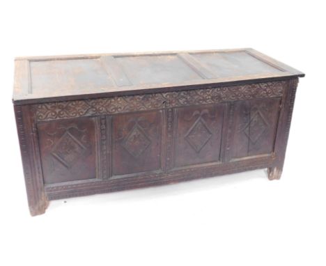 A 17thC oak coffer, with three panel top, Arabesque carved frieze, four lozenge carved panels to the front, raised on stiles,