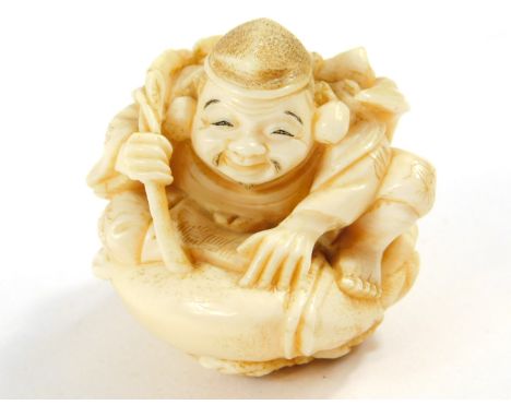 A Japanese ivory netsuke of Ebisu, seated on his giant carp, Meiji period, 6cm High.