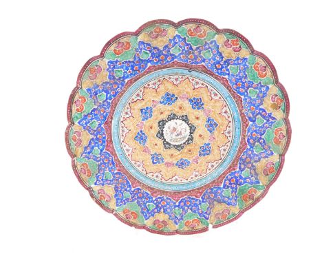 A Persian fluted 19thC enamel dish, painted centrally with birds within repeating floral borders, 22cm diameter.