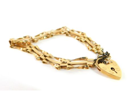 A 9ct gold three bar gate bracelet, on a heart shaped padlock clasp, with safety chain as fitted, 6.9g.