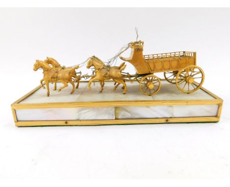 A French Palais Royale type ormolu and mother of pearl model of a cart, being drawn by four horses, raised on a rectangular p