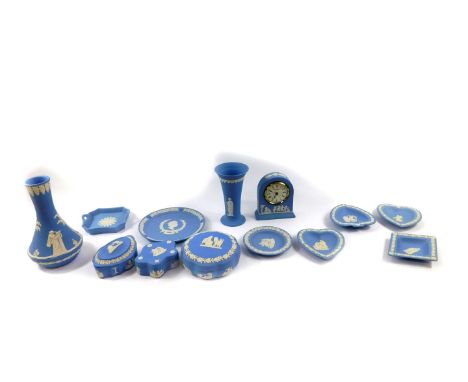 A group of Wedgwood light blue Jasperware, mostly boxed, including a mantel clock, vase, boxes and covers, twin handled dish,