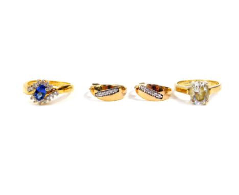 A Royal Tru sapphire and cubic zirconia ring, set in yellow metal, in a crossover design, size M, 3.0g., a pair of cubic zirc