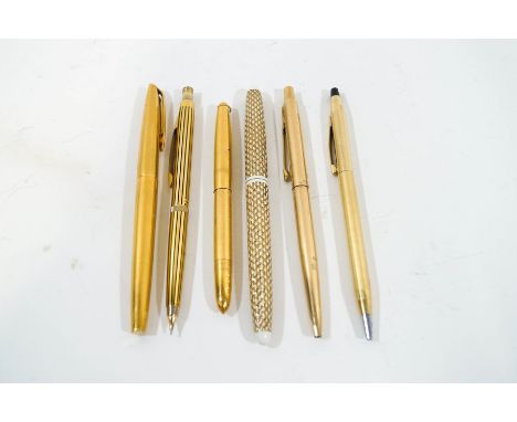 A Sheaffer fountain pen with textured cream and gold tone body, a Waterman fountain pen with 18K nib, a small Edacoto fountai