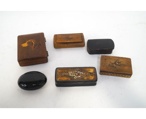 A wooden cigarette box, the lid inlaid with a dog's head, and five 19th century snuff boxes, including an Italian olive wood 