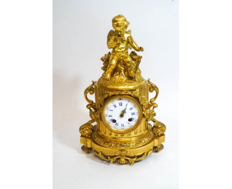 A French ormolu eight day mantel clock, cast as a half Classical column with floral swags and surmounted by a cherub, enamel 