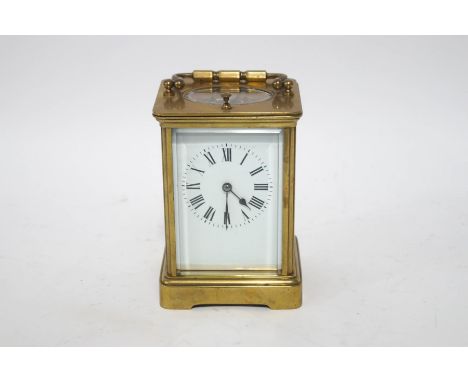 A brass quarter repeater carriage clock with winding key, 17cm high including carrying handle