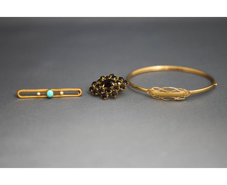 A 9 carat gold bangle; a turquoise and seed pearl bar brooch, stamped '9ct'; 7 g gross; and a paste brooch