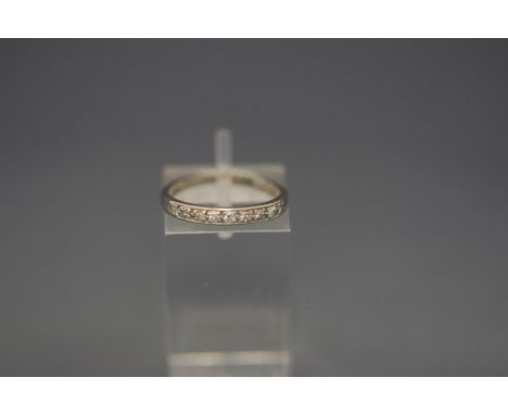 A seven stone diamond half hoop ring, stamped 'Pla', finger size K, 2.1 g gross