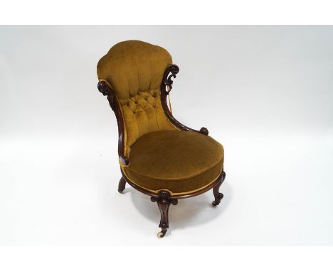 A Victorian rosewood button back nursing chair, with scroll frame and legs, 57cm wide