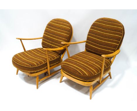 A pair of Ercol blonde wood stick back armchairs, with original cushions