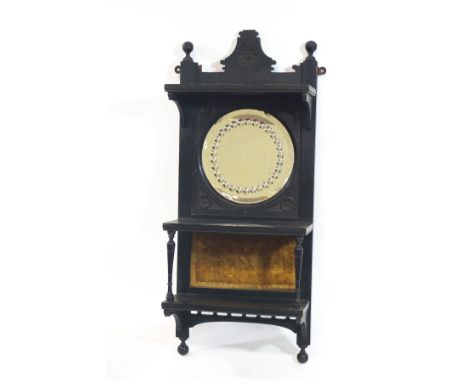 A Victorian ebonised hanging wall shelf, with inset circular mirror, 69cm high x 30cm wide