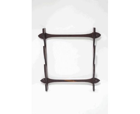 An oak hanging wall bracket with shaped supports to display weapons, 82cm high x 77cm wide overall