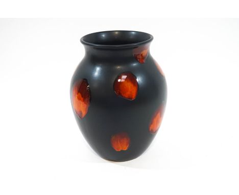 A Poole Pottery 'Living Glaze' baluster vase, raised orange red spots over a matte black ground, printed factory mark, 24cm h