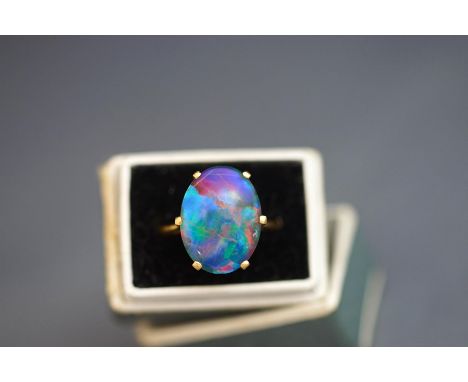 An opal triplet ring, unmarked, finger size K, 5 g gross, cased