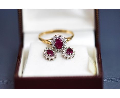 A 9 carat gold ruby and diamond cluster ring, finger size R1/2; and a similar pair of earstuds, cased; 3.4 g gross