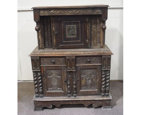 A 17th century style oak court cupboard incorporating 17th century elements with one cupboard door above two drawers above tw