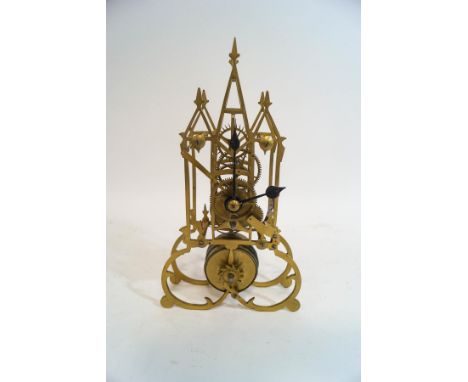 A brass cased bedside/mantel clock, possibly Trench art, the top being a removable lid, 10cm high, and a brass skeleton clock