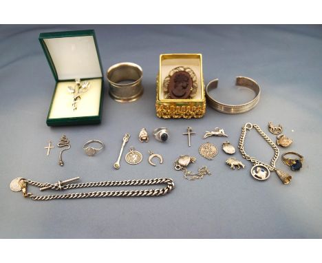 A collection of silver jewellery and other items, including brooches, bangle, albert chain, rings, charms, and a napkin ring