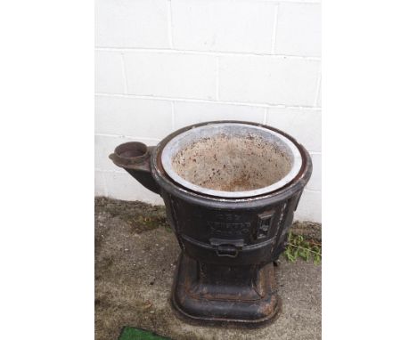 A cast iron log boiler converted into a planter, 7cm high x 78cm at widest point