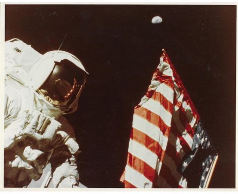 
	
		Eugene Cernan
		Harrison Schmitt with the Earth above the deployed American flag, the photographer reflected in the viso
