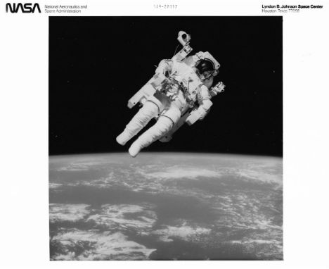 
	
		A view of Bruce McCandless floating freely during the first ever untethered spacewalk, accompanied by a striking view of