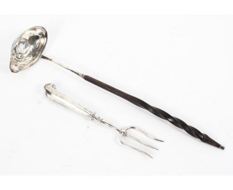 A coin set white metal toddy ladle with turned handle together with a sterling silver toasting fork