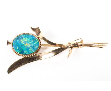 A yellow metal bar brooch principally set with blue opal doublet measuring approximately 13.0mm x 10.0mm. No hallmarks; un-te