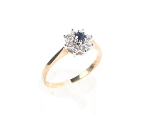 A 9ct gold sapphire and diamond flower ring. Central round cut sapphire with a surround of 8 single cut diamonds. 1.7g. Size 