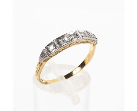 A yellow and white metal ring set with single cut diamonds estimated to weigh a total of 0.05cts. No hallmark; tests indicate