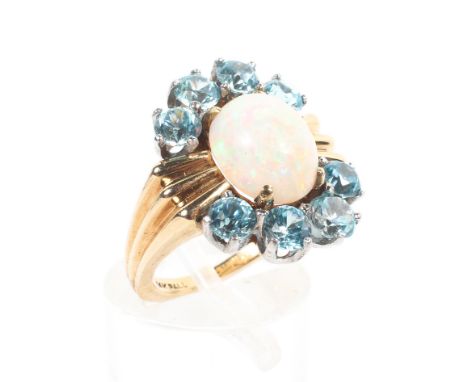 A 14ct gold abstract cluster ring principally set with an oval cabochon opal measuring approximately 9.50mm x 8.00mm x 4.60mm