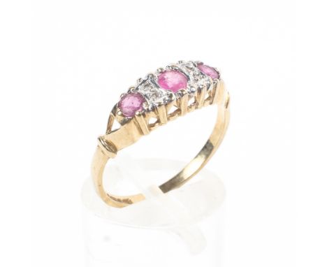 A 9ct gold ruby and diamond ring set with three free cut rubies with single cut diamond accents. 1.7g Size N. 