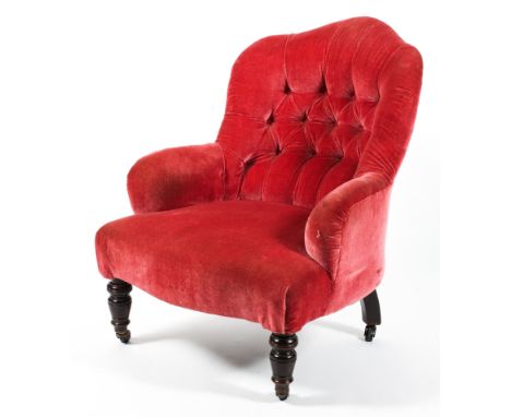 A Victorian button back pink armchair, with shaped back and turned feet, on casters, 87 cm high 