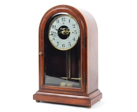 An Electric Boule mahogany mantel clock, of arched rectangular form with silvered dial with black Roman numerals, 35 cm high