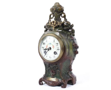 A French 'bronzed' metal striking mantel clock, late 19th century, the scroll and floral cast baluster case surmounted with s