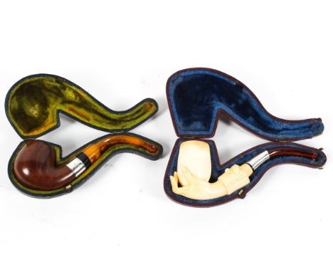 A carved meerschaum pipe and a wooden example, the first carved with a hand holding the bowl, cased, 15 cm long, the other wi