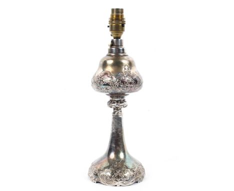 A silver plated baluster lamp base, early 20th century, embossed with scrolls and flowers, fitted for electricity, 33 cm high
