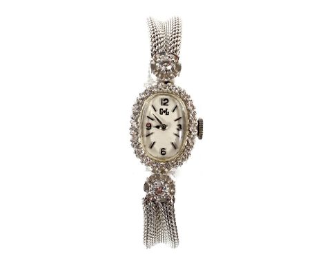 A vintage ladies 14ct white gold and diamond wristwatch, the dial with baton hour markers and Arabic quarter hour markers, th
