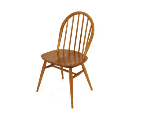 A set of four light Ercol stick back kitchen chairs 