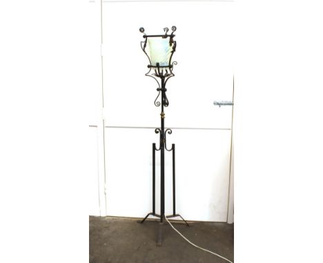 A wrought iron and brass mounted adjustable lamp standard, with Vaseline glass shade converted to electricity