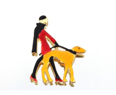 An Art Deco design enamel decorated brooch, depicting a lady walking a dog