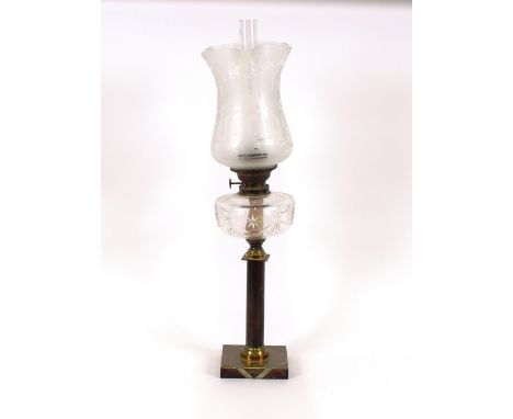 A brass and bronzed oil lamp, having clear glass font and etched shade