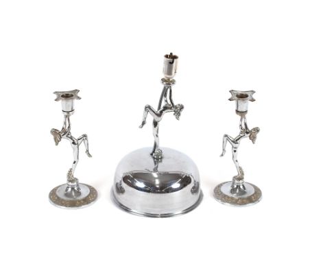 A chrome Art Deco table lamp, and matching candle holders in the form of naked dancing girls