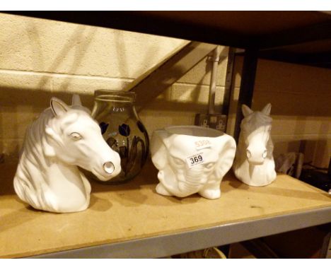 Two ceramic horse heads and a ceramic elephant