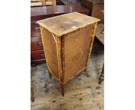 A vintage bamboo one door cupboard